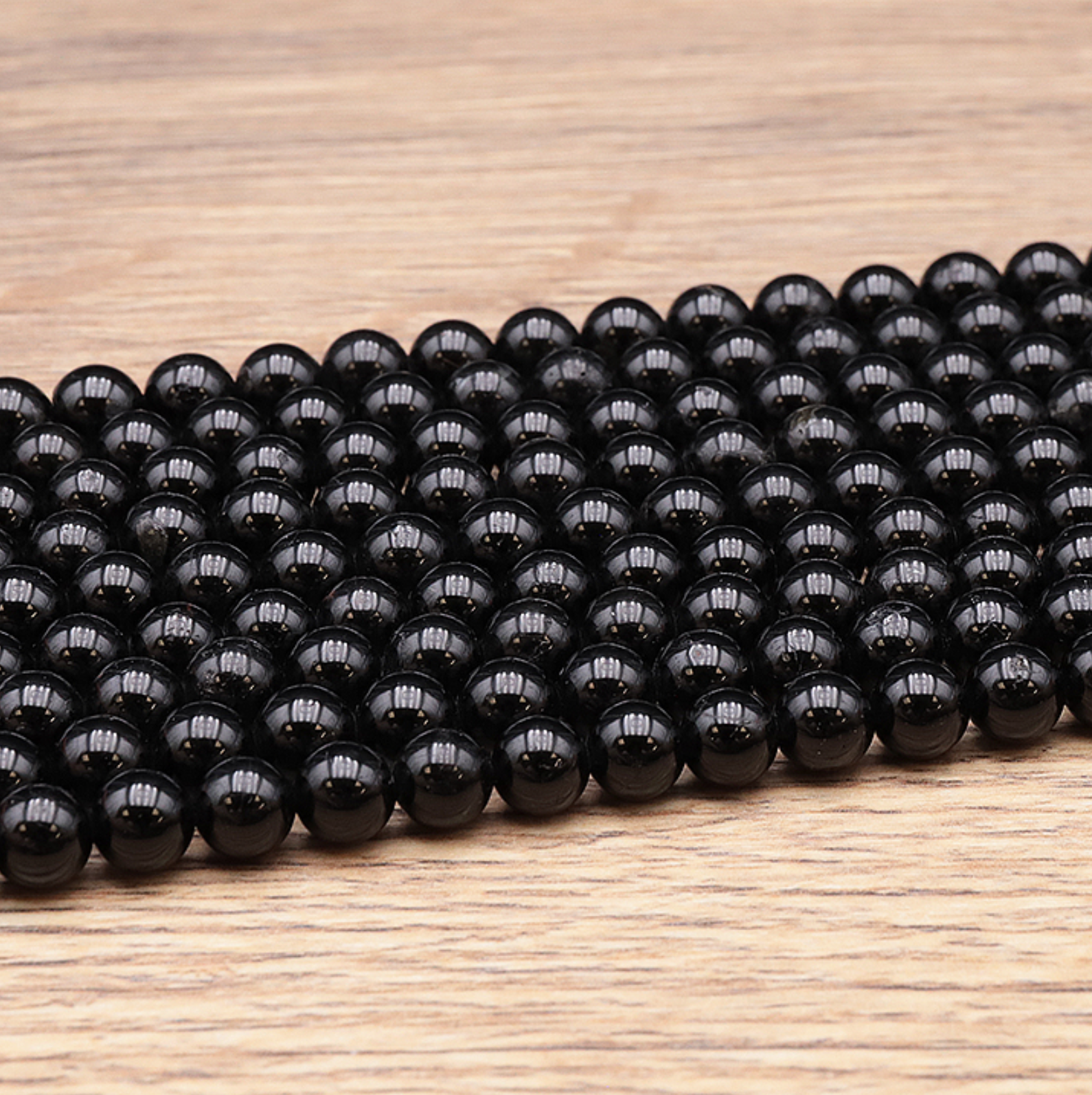 FIL DE PERLES 06MM TOURMALINE NOIRE A